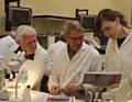 Liza Kavanagh (right) with Marsden National Trust volunteer Nick Pollett, (left) and John Smithson, of Huddersfield and District Archaeology Society (centre) analysing peat at the University of Bradford 