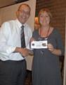 Sue Furby presenting Kit Wellens with his prize donated by The Halfway House, Royton