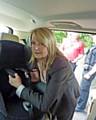 Casualty Reduction Community Liaison Officer Jacqui Hogg fits a child’s car seat in Milkstone, supported by colleagues and officers from Greater Manchester Police