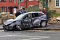 The badly damaged stolen car and demolished garden wall