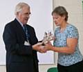 Councillor Martin Burke presenting the award to Deputy Head, Helen Wilkinson