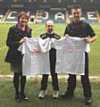 Crime Prevention Officer Jacqui Bell and PC Nathan McLean, present Sunrise Team T—Shirts to Rochdale AFC kitman Jack Northover