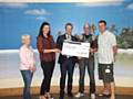 Michael Unsworth receiving the cheque from the Zen team