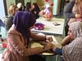 Health and Social Care student Nafisah Syede doing henna art on a customer’s hand