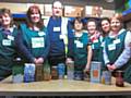 Rochdale Foodbank Volunteers with items of food we are really short of