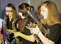 Falinge Park High School music students performing at the 'Dynamite' Music Concert -  Natasha Waddington, Hannah Beech and Abbey Smith in Year 9
