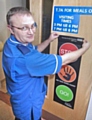 Infection control nurse Mark Ronan displays the new posters at The Royal Oldham Hospital