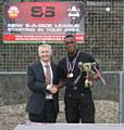 Hopwood Hall College team captain Lloyd Bailey receiving the winners trophy at 2013 Olympiad from John Spindler, Deputy Principal, Hopwood Hall College 