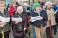 Susan Forsyth (green beret) leads the Zusammen Choir Procession