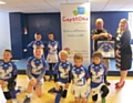 Mayfield under 8s with Ian Kershaw presenting framed shirt to Yvette Schemet from Capstone Fostercare