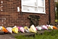 Floral tributes left in the garden of the Rigby family's home on the Langley estate