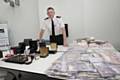 ACC Steve Heywood with the recovered nearly £7 million from criminals