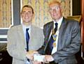 David Smithard, President of Rochdale Rotary Club presents a cheque Denis Skelton, Coordinator for the Rochdale Petrus Community Charity