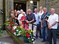 The Pennines in Bloom team outside Milnrow Library – complete with flowering pots, hangers, etc