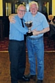 Ian Smith from the Rotary Club of Rochdale East receives the trophy from the President of host club Heywood Rotary Club, Edwin Partridge