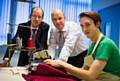 Jonny Carroll (right) showing off his sewing skills to Councillor Colin Lambert and David Moore, managing director of Headen & Quarmby 
