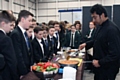 Students watch Councillor Farooq Ahmed holding a cookery demonstration at the Veenas Restaurant stand