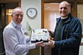 Steve Barton presents a cake from Peter Ross to Chris Bell