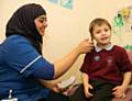 Young patient Tyla Warburton, 5 years old from Rochdale and a pupil from Whittaker Moss Primary School, with staff nurse Rabia Khanam at the Urgent Care Centre