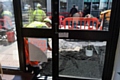 Workmen digging directly outside the door of 25 Ten Boutique