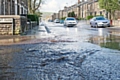 A torrent of water cascading down Huddersfield Road, Newhey