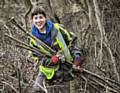 Emily stacking off-cuts into a dead hedge