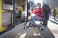 Sheila Rawcliffe boards a Metrolink tram on her approved mobility scooter using her new permit