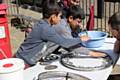 A group of young people from Sparth Youth Club and junk sculptor Richard Dawson creating a piece of artwork