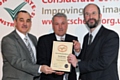 Steve Balyski Operations Manager and Jim Connell Contract Director receiving the National Site award from William Swan, Director of Constructing Excellence in the North West