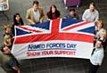 The council’s Acting Chief Executive Linda Fisher with Harry Scrope a retired Major in the Coldstream Guards and staff with one of the flags that will be raised across the borough on the run up to national Armed Forces Day