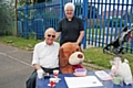 Vicar Maureen Thorp with Henry West and the prize for guessing the amount of balloons in a car