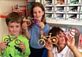 Children at the Star Tree Studio decorate wooden bicycles for the Tour de France