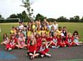 Members of St Margaret’s Rainbows, Brownies and Guides with their apple tree