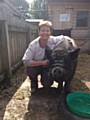 Lynne Coxell poses with one of the two micro-pigs looked after by pupils at St Edward's School
