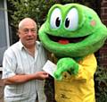 Springy hands a cheque to Mr Owen who won £5,000 in Springhill Hospice’s Summer Bumper draw