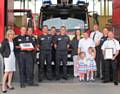 Green Watch Heywood with (far left) Kim Leitch from WOW! Awards, (far right) crew manager Dave Dawson, (rear second right) Rochdale Borough Manager Paul Starling and nominator Katie Bartle with family