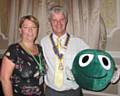 Helen Matthews, the Schools Service Area Coordinator ChildLine North West with the President of the Rotary Club of Rochdale, Bob Chadwick holding Buddy, a large, green, cuddly speech bubble 