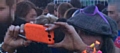 New image of witness picture seven: Female, brown hair, flat cap, black top, pink framed sunglasses.