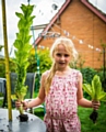 Claire's daughter Amber Jones with the tall Little Gem lettuce