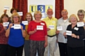 The Littleborough U3A committee hold up the interest group cards