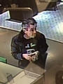 CCTV image of a man police wish to speak to in connection with a string of high-value frauds