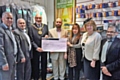 Mohammed Javed presenting a cheque for £500 to the Mayor and Mayoress