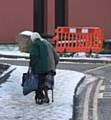 Two elderly ladies support each other on the slippy paths