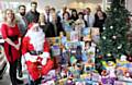 Helen Leach (left) from Rochdale Borough Council meets Father Christmas and the team at Swansway Honda. The company have donated £500 of toys to the council staff run appeal