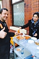 Councillor Shefali Ahmed serving food to one of the volunteers helping with the clean up