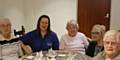 Diane Smeaton (second from left) from Concept Heating and RBH Project Development Officer Darrione-Rose Penlington (second from right) join Chisholm Court residents as they get ready for their celebratory lunch