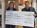 Mike Goldrick presents a cheque for £1,000 to Elaine McConnell of Springhill Hospice