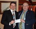 President elect Chris Kelly handing a Cheque for £500 to Phil Emmott from Recovery Republic