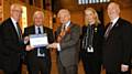 Middleton Rotarian John Brooker receiving his Champion of Change Award with Lord Wallace MP and Rotary Great Britain and Ireland President Peter King