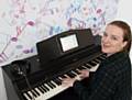 Sarah Barron plays the new digital piano at Rochdale Central Library